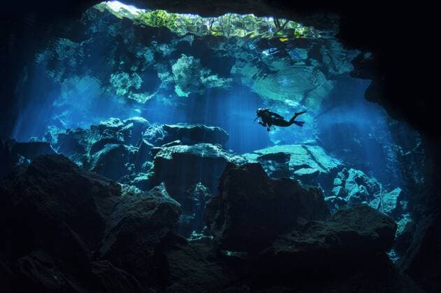 A diver explores Chac Mool Cenote. Puerto Aventuras, Quintana Roo, Mexico. Model released.  1436080 AlexxMustard