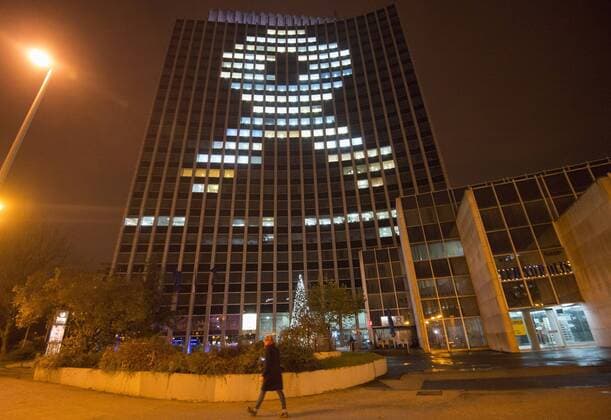 (141201) -- ZAGREB, Dec. 1, 2014 -- Zagrepcanka office building is illuminated with the image of red ribbon in Zagreb, Croatia, Dec. 1, 2014. The red ribbon is the universal symbol of awareness and support for those living with HIV. Croatian Medical Students-International Committee (CroMSIC) organized the event to mark World AIDS Day and to raise awareness of the AIDS pandemic caused by the spread of HIV infection. ) CROATIA-ZAGREB-WORLD AIDS DAY MisoxLisanin 