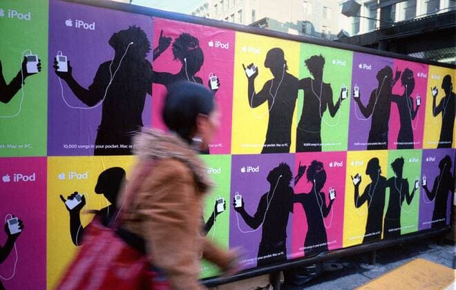 Antitrust lawsuit against Apple Posters for the wildly popular Apple Computers iPod cover a wall on October 19, 2003. An antitrust lawsuit against Apple contends that Apple allegedly conspired to block music from competing music service from playing on their iPods. (© Richard B. Levine)  RICHARDxB.xLEVINE
