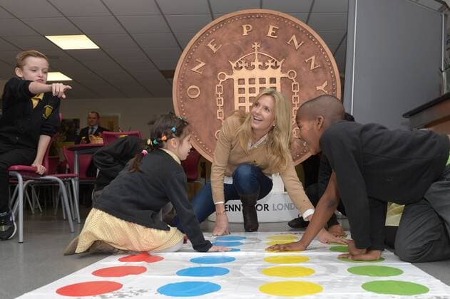 . 18 12 2014. London, United Kingdom. Penny Lancaster visits Charlton Manor Primary School where the Mayors Fund initiative Penny for London is raising money to fund breakfasts for school children. Penny Lancaster plays Twister with children at breakfast club. xBenxStevensx xi-Imagesx IIM-3778-0002