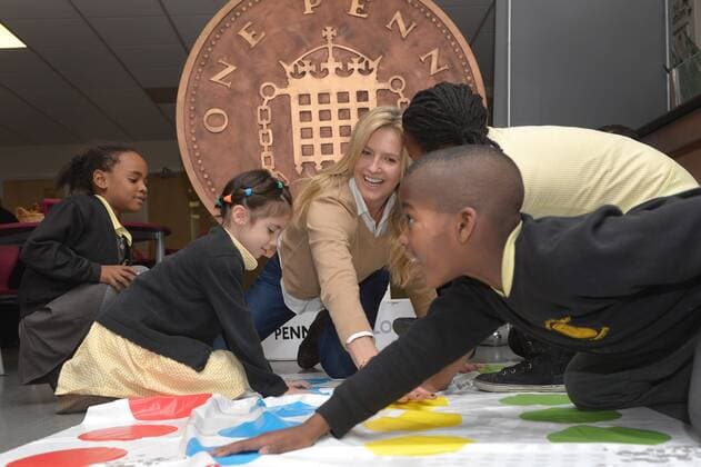 . 18 12 2014. London, United Kingdom. Penny Lancaster visits Charlton Manor Primary School where the Mayors Fund initiative Penny for London is raising money to fund breakfasts for school children. Penny Lancaster plays Twister with children at breakfast club. xBenxStevensx xi-Imagesx IIM-3778-0004