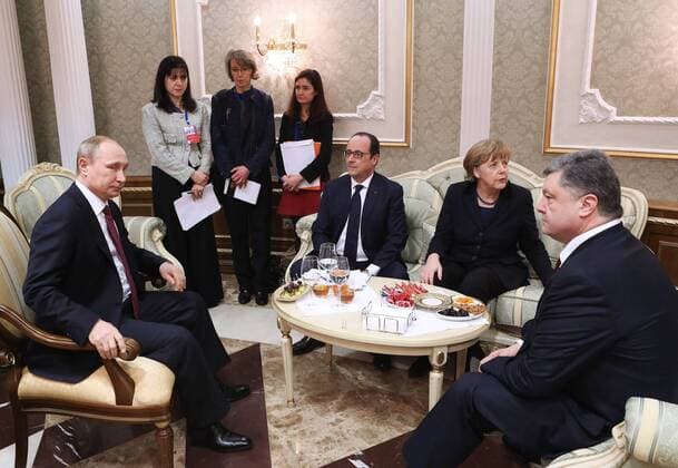MINSK, BELARUS. FEBRUARY 11, 2015. Russia s president Vladimir Putin, France s president Francois Hollande, Germany s chancellor Angela Merkel and Ukraine s president Petro Poroshenko (L-R seated) seen ahead of Normandy format Ukraine peace talks at the Palace of Independence in Minsk. Nikolai Petrov BelTA TASS  RE15BA23