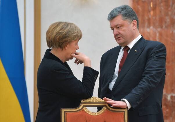 MINSK, BELARUS. FEBRUARY 11, 2015. Germany s chancellor Angela Merkel (L) and Ukraine s president Petro Poroshenko seen during Normandy format Ukraine peace talks at the Palace of Independence in Minsk. Alexei Druzhinin Russian presidential press service TASS  RE15BA79
