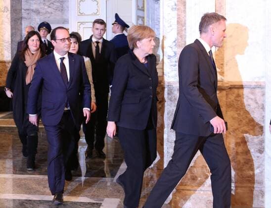 MINSK, BELARUS. FEBRUARY 12, 2015. France s president Francois Hollande (L) and Germany s chancellor Angela Merkel (C) seen during a break in Normandy format Ukraine peace talks at the Palace of Independence in Minsk. Nikolai Petrov BelTA TASS  RE15BAB0