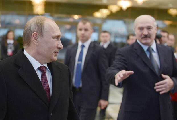 MINSK, BELARUS. FEBRUARY 12, 2015. Russia s president Vladimir Putin (L) and Belarus president Alexander Lukashenko (R) seen after Normandy format Ukraine peace talks at the Palace of Independence in Minsk. Viktor Drachev TASS  RE15BADF