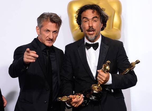 Alejandro Gonzalez Inarritu, winner of Best Director and Best Picture for Birdman poses with actor Sean Penn backstage with his Oscars during the 87th Academy Awards at the Hollywood & Highland Center in Los Angeles on February 22, 2015.  LAP20150222605 JIMxRUYMEN