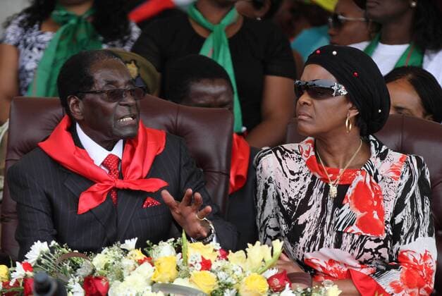 (150228) -- VICTORIA FALLS (ZIMBABWE), Feb. 28, 2015 () -- Zimbabwean President Robert Mugabe (L) and his wife Grace Mugabe chat on the podium at a public celebration held to mark his 91st birthday in Victoria Falls, Zimbabwe, Feb. 28, 2015. Mugabe, who turns 91 this month, is the oldest leader in the world and one of the longest-serving African statesmen. Having ruled Zimbabwe for 35 years since independence, Mugabe was endorsed by the ruling ZANU-PF party as the sole candidate to contest at the age of 94 in the next presidential election in 2018. () ZIMBABWE-VICTORIA FALLS-MUGABE-BIRTHDAY Xinhua 