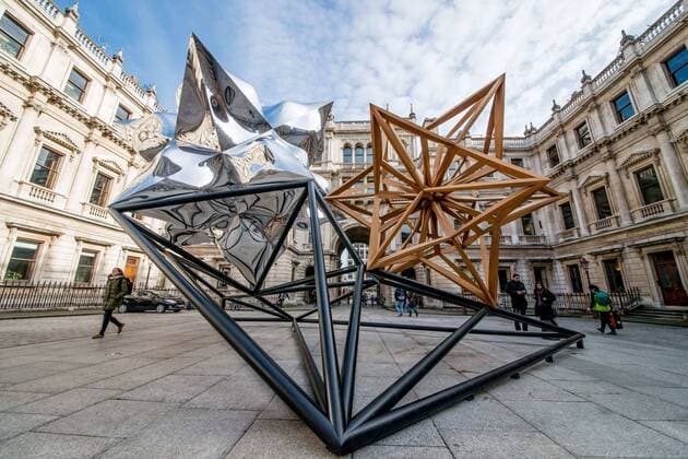 April 2, 2015 - Frank Stella Hon RA is one of the most important living American artists. His Inflated Star and Wooden Star is exhibited in the UK for the first time.The sculpture has been fabricated from aluminium and teakwood. Conceived digitally, the image is modelled and refined by Stella to the verge of minimalism before it goes into production. - ZUMAg173