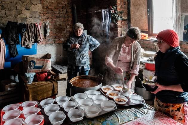 April 6, 2015 - Pisky, Donetsk Oblast, Ukraine - Volunteers helping at the preparation of hundred of meals that they are going to serve that day. On April 6 2015, we visit Krasnogorovka. What we saw is the evident beginning of a serious humanitarian crisis. People living in unhealthy conditions, surround by mountains of rubbish, deficient water system, no windows, electricity, etc. We visit the city with the help of Pastor Vladimir Ivanov, director of the NGO Ã‚Â« Good News Church Ã‚Â». Krasnogorovka is under control of Ukrainian army and it is a small suburb west of the separatist stronghold city of Donetsk. If the city is calmed, population on the limit of the town have to be aware of the presence of snipers 800 meters away in the separatist zone. Pastor Ivanov go to Krasnogorovka once a week to bring food, clothes, candy for kids in a city that is let to itself. We saw elderly people  - ZUMAn230