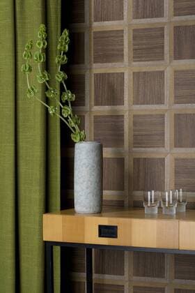 Sideboard with glasses and flower vase in front of wooden wall cladding  PATF000026