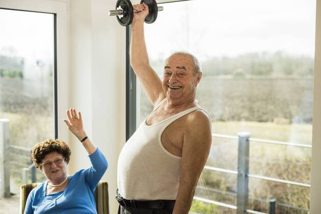 Senior man with dumbbell at home model released Symbolfoto property released  UUF003585