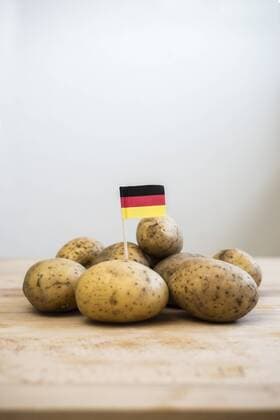 Row potatoes and small german little flag on wood  CHPF000122