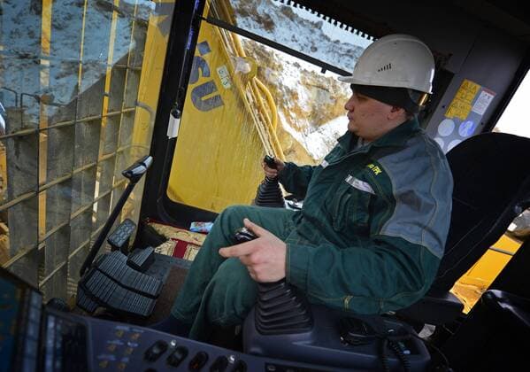 SAKHA, RUSSIA. APRIL 20, 2015. An excavator driver loading gold ore into a truck on the grounds of the Kuranakh gold field owned by AldanZoloto Mining Company. AldanZoloto is a subsidiary of Polyus Gold. Yuri Smityuk TASS  TS000934