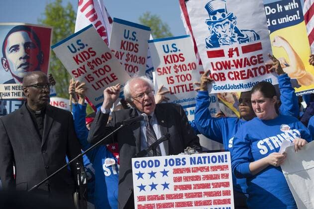 Senator Bernard Sanders (I-VT) speaks alongside protesters advocating for an increase in the minimum wage to $15 per hour, as part of a Fight for $15 rally on Capitol Hill, in Washington, D.C. on April 22, 2015.  WAP20150422317 KEVINxDIETSCH