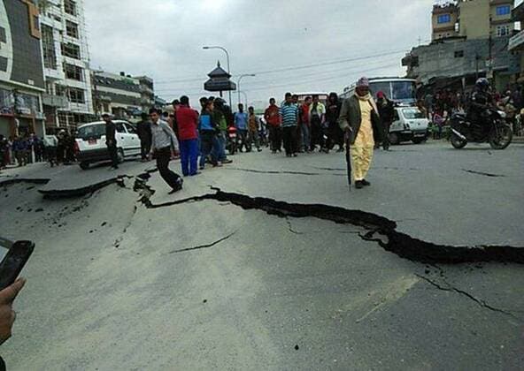 (150425) -- KATHMANDU, April 25, 2015 -- People walk on a damaged road in Kathmandu, capital of Nepal, on April 25, 2015. More than 100 people have been killed in a powerful earthquake which hit large parts of Nepal on Saturday, including dozens in capital Kathmandu, sources here said. ) NEPAL-KATHMANDU-EARTHQUAKE-AFTERMATH Stringer 