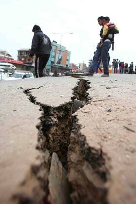 Damaged roads are seen after an earthquake on the outskirts of Bhaktapur in Nepal, on April 26, 2015. New tremors sent shocked survivors scurrying outdoors just 24 hours after a devastating 7.9 magnitude earthquake shook the region which so far has taken the lives of at least 2,500 people.  NEP2015042611 SanjogxManandhar