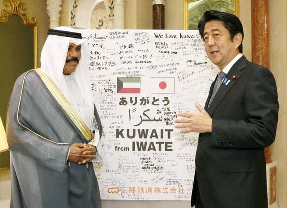 KUWAIT CITY, Kuwait - Japanese Prime Minister Shinzo Abe (R) presents a collection of thank you messages from residents of Iwate Prefecture, northeastern Japan, to Kuwaiti Crown Prince Sheikh Nawaf Al-Ahmad Al-Jaber Al-Sabah in Kuwait City on Aug. 26, 2013. The messages were to thank Kuwait for assistance offered to a railway company in Iwate that suffered severe damage to its infrastructure in the March 2011 tsunami.  0826020