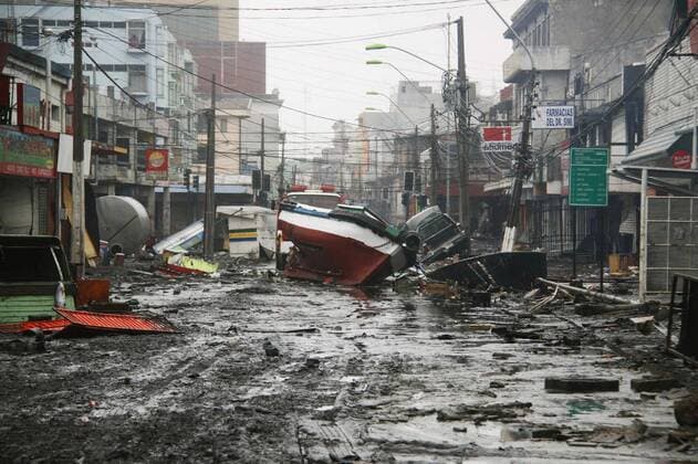 CONCEPCION, Chile - A boat washed away from a port by tidal waves sits among rubble littering a street in Talcahuano, Chile, on March 1, 2010, following a devastating earthquake that struck the country on Feb. 27.  0302007