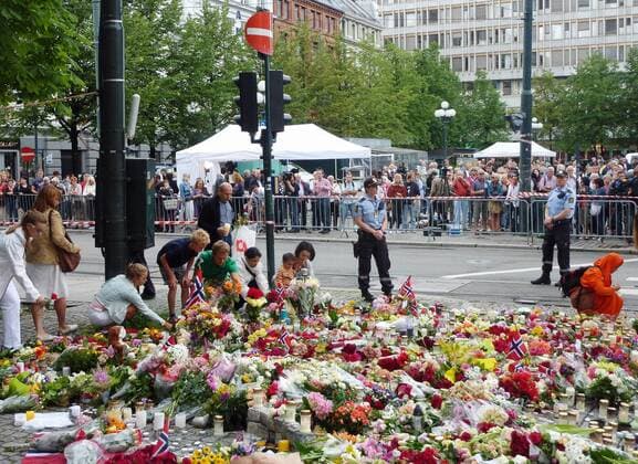 OSLO, Norway - People offer flowers near a cathedral in Oslo, Norway, on July 24, 2011. The cathedral held a mass the same day to mourn the dozens of victims of attacks by a man in Oslo and the island of Utoya on July 22.  0725007