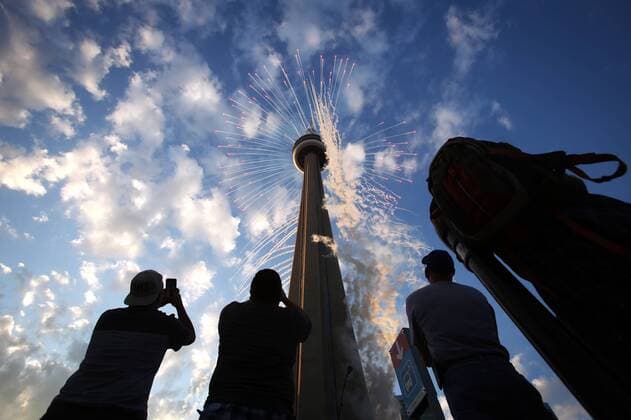 July 10, 2015 - Toronto, Ontario, Canada - Toronto, Canada - July 10 - People watch fireworks shoot out of the CN Tower at the start of the Opening Ceremonies of the Pan Am games, outside of the Rogers Centre in Toronto July 10, 2015.. Toronto Canada  - ZUMAt14_