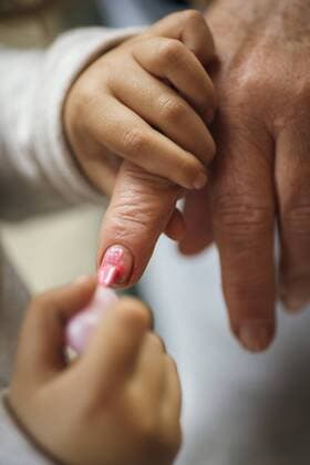Little girl painting her grandmother s finger nails model released Symbolfoto  MGOF000274