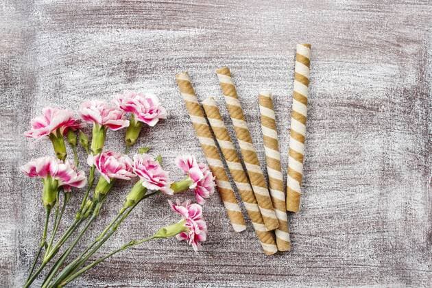 Geburtstag - Symbolbilder Striped wafer rolls, delicious chocolate snack and bouquet of carnation flowers.  Copyright: KantarukxAgnieszka bew1852AD1