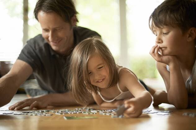 Father playing with his children, lying on floor model released Symbolfoto  MAO000051