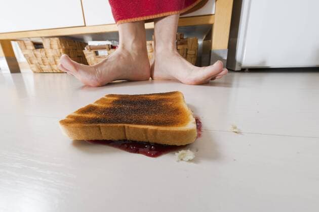 Toast with jam lying backwards on floor model released Symbolfoto property released  VIF000359