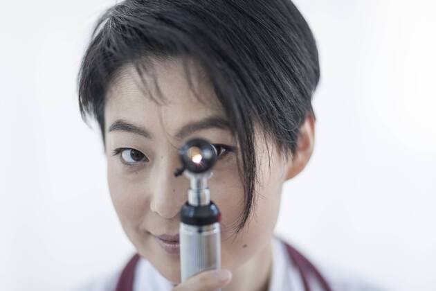 Portrait of smiling doctor with otoscope model released Symbolfoto property released  ZEF006264