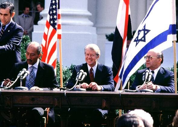 Aug. 27, 2002 - Washington, District of Columbia, United States of America - President Anwar Sadat of Egypt, United States President Jimmy Carter, and Prime Minister Menachem Begin of Israel sign the Camp David Peace Treaty on the North Lawn of the White House on March 26, 1979..Credit: Washington United States of America - ZUMAs152