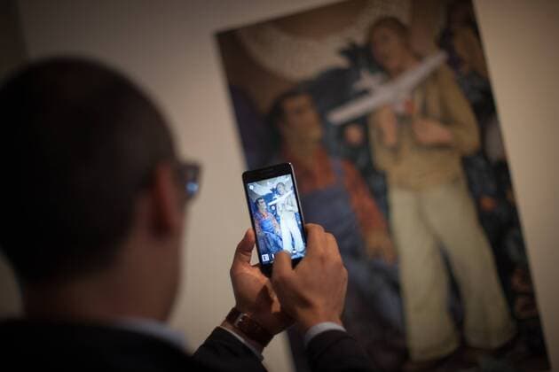 (150828) -- MEXICO CITY, Aug. 28, 2015 -- A man takes a photography to one of the works in the exhibition Diego Pop, Frida Pop in Mexico City, capital of Mexico, on Aug. 28, 2015. The exhibition, about Mexican artists Diego Rivera and Frida Kahlo on their influence in American culture, will last to Sept. 7. Pedro Mera) (jg) MEXICO-MEXICO CITY-CULTURE-EXHIBITION e PedroxMera 