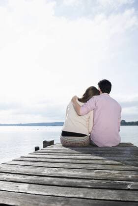 Couple hugging sitting lake jetty tranquil mit_2002_06261