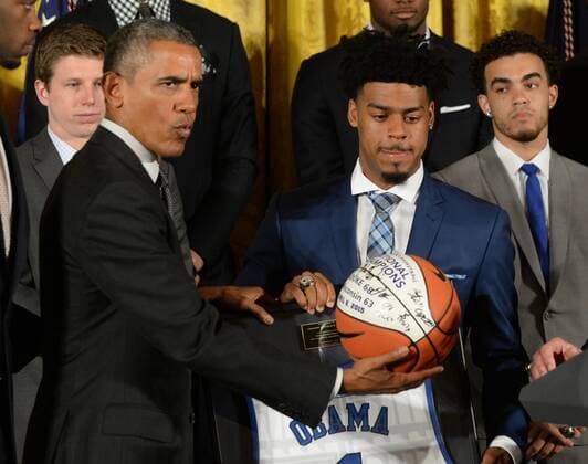 U.S. President Barack Obama looks at a Duke team basketball he was given during a celebration event in the East Room of the White House in Washington, DC on September 8, 2015. The Duke Blue Devils won the NCAA college basketball championship in March of 2015.  WAP2015090810 PATxBENIC