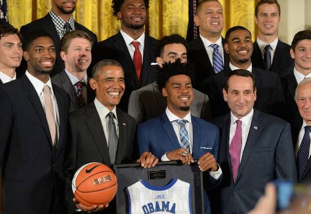 U.S. President Barack Obama holds a Duke team basketball he was given during a celebration event in the East Room of the White House in Washington, DC on September 8, 2015. At right is Duke head basketball coach Mike Krzyzewski. The Duke Blue Devils won the NCAA college basketball championship in March of 2015.  WAP2015090811 PATxBENIC