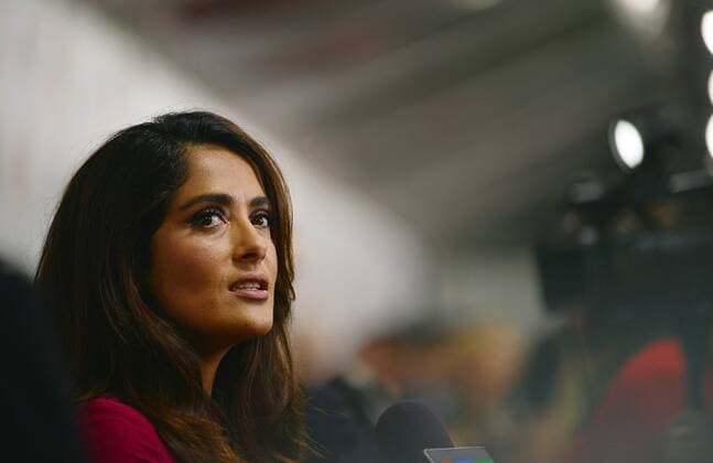 Salma Hayek speaks with television reporters on the red carpet as she arrives at the world premiere of Septembers of Shiraz at Roy Thomson Hall during the Toronto International Film Festival in Toronto, Canada on September 15, 2015.  TOR2015091522 CHRISTINExCHEW