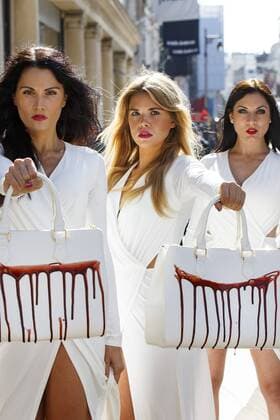 Sept. 17, 2015 - London, London, UK - London, UK. PETA models holding brandishing handbags covered in fake blood to protest against the use of animal skins in London Fashion Week on Thursday, 17 September 2015 in central London. London UK  - ZUMAl94_