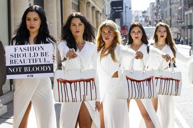 Sept. 17, 2015 - London, London, UK - London, UK. PETA models holding brandishing handbags covered in fake blood to protest against the use of animal skins in London Fashion Week on Thursday, 17 September 2015 in central London. London UK  - ZUMAl94_