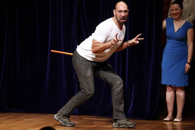 Bruno Grossi of the Universidad de chile, Santiago, demonstrates the research he and his team did to win the 2015 Ig Nobel Prize in Biology for observing that when you attach a weighted stick to the rear end of a chicken, the chicken then walks in a manner similar to that in which dinosaurs are thought to have walked, at the awards ceremony at Harvard University in Cambridge, Massachusetts on September 17, 2015. The prizes which are awarded by the Annals of Improbable Research are intended to celebrate the unusual, honor the imaginative and spur people s interest in science, medicine, and technology.  BOS2015091705 MATTHEWxHEALEY