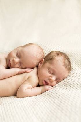 Newborn twins sleeping on blanket model released Symbolfoto  SHKF000341
