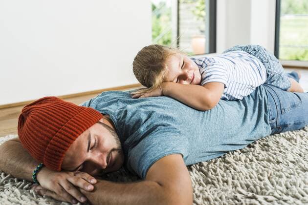 Father and daughter sleeping on rug at home model released Symbolfoto property released  UUF005162