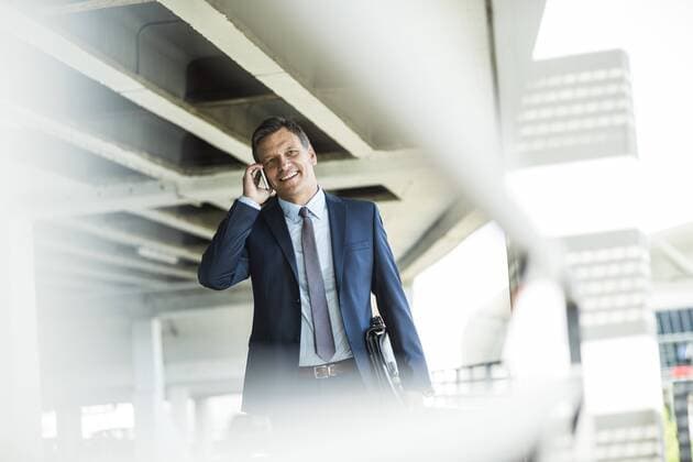 Mature businessman on park deck using mobile phone model released Symbolfoto  UUF005289
