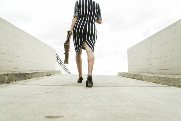 Young businesswoman walking on parking deck model released Symbolfoto  UUF005343
