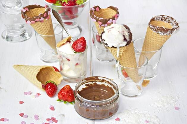 Ice-cream cones with ice-cream, decorated with chocolate and coconut flakes, sugar hearts  YFF000447