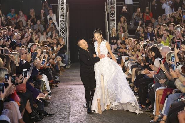 . 19 09 2015. London, United Kingdom. Designer Julien Macdonald helps a model who trips at the finale of his show at London Fashion Week-S S 2016-Day two.  xStephenxLockx xi-Imagesx IIM-11062-0041