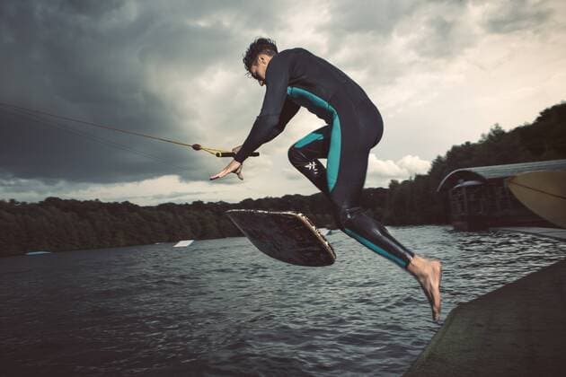 Young wakeboarder jumping in the air model released Symbolfoto property released  MADF000494