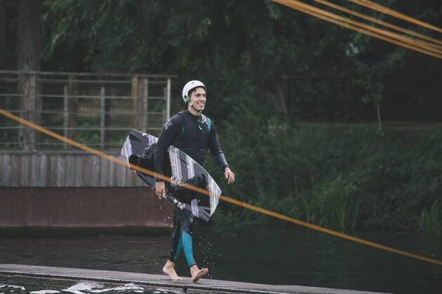 Young man carrying his wakeboard model released Symbolfoto property released  MADF000506