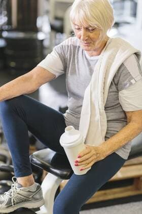 Senior woman in gym having a break model released Symbolfoto property released  MADF000515
