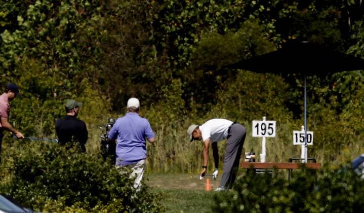 US President Barack Obama stretches before playing golf at Renditions Golf Club in Davidsonville, Md, on September 19, 2015. Pool photo by Aude Guerrucci  WAX20150919905