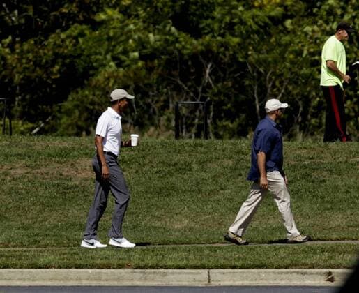 US President Barack Obama stretches before playing golf at Renditions Golf Club in Davidsonville, Md, on September 19, 2015. Pool photo by Aude Guerrucci  WAX20150919906