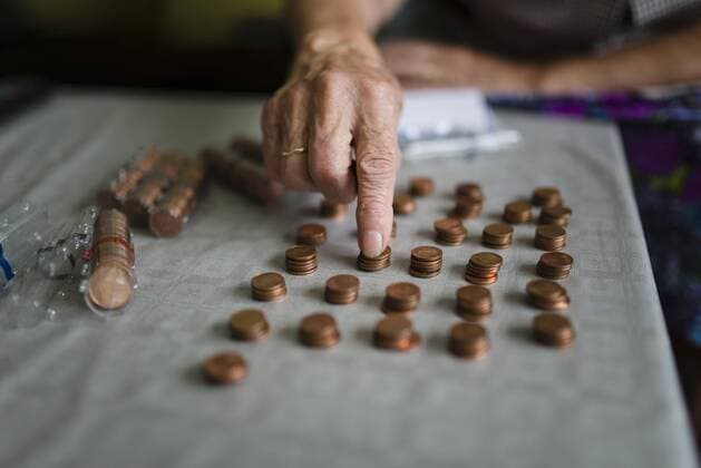 Elderly woman counting money, making stacks of Euro cents model released Symbolfoto  RAEF000410